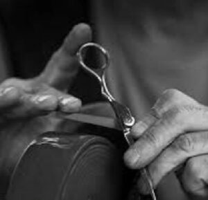 A person holding scissors in their hands.