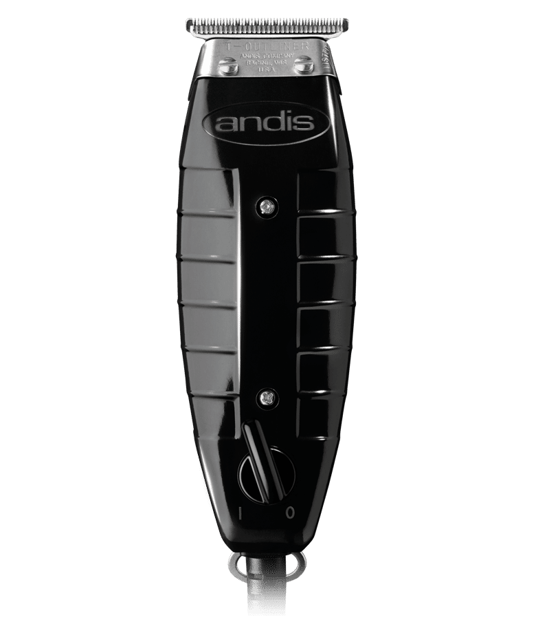 A black and silver hair trimmer sitting on top of a green background.