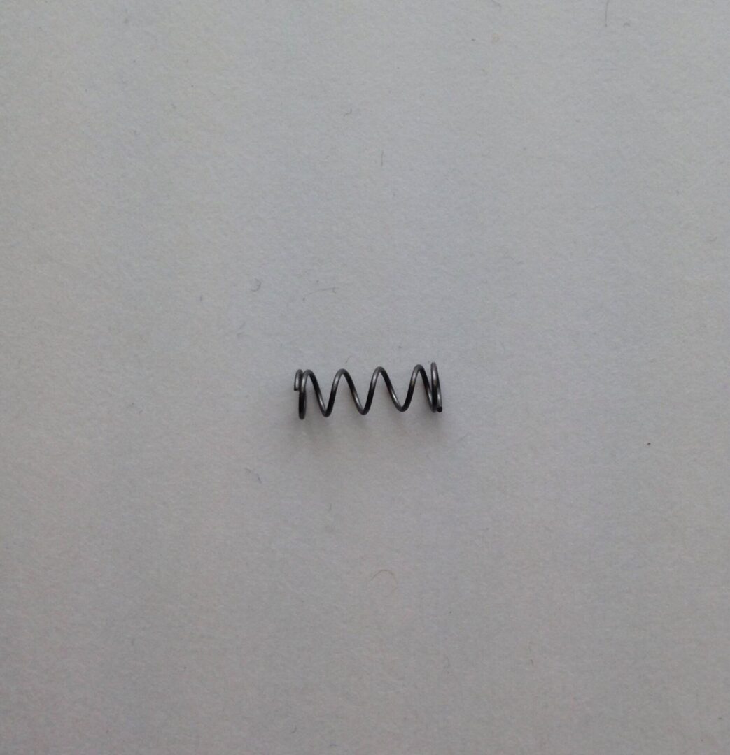 A small metal coil sitting on top of a wall.