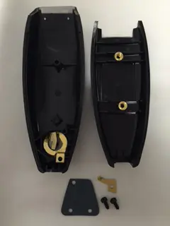 A black plastic case with two keys and one key hole.