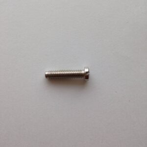 A close up of a screw on the side of a wall