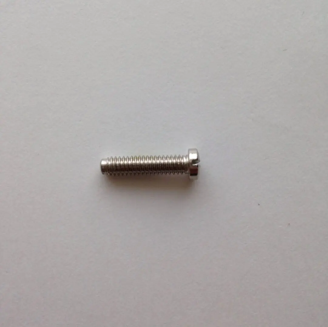 A close up of a screw on the side of a wall