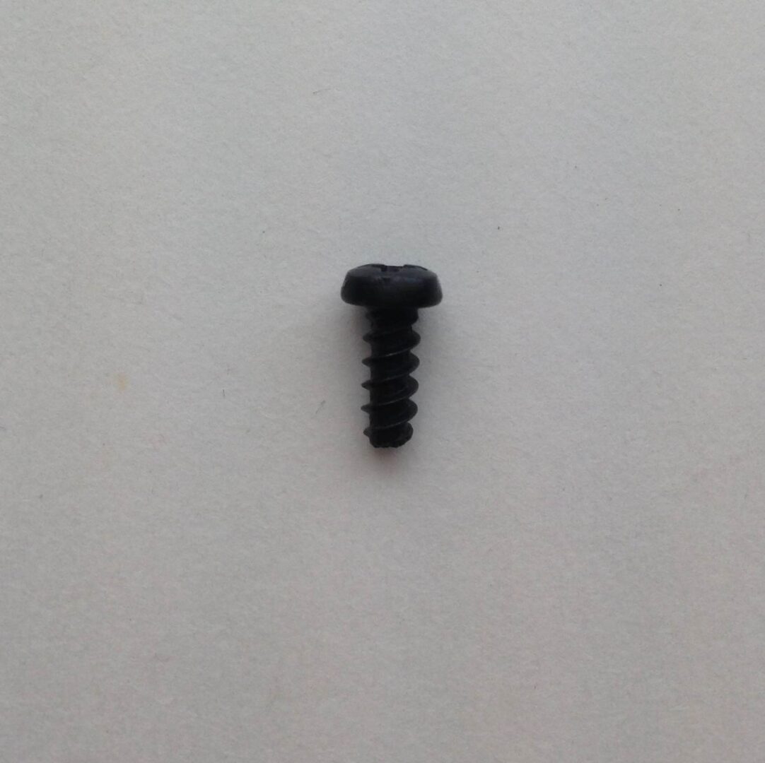 A black screw is on the wall