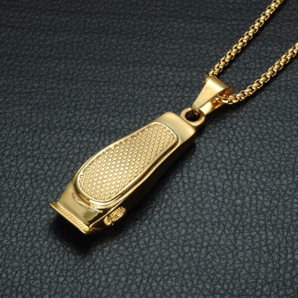 A gold plated necklace with a metal nail clipper.