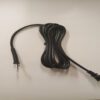 A black cord with an ear bud hanging on it.