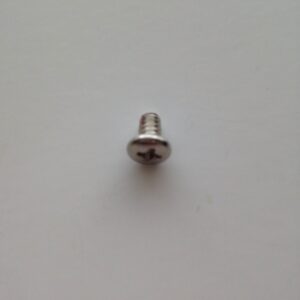 A close up of the screw on top of a white surface