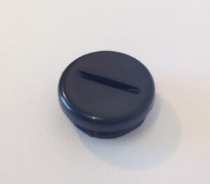 A black button sitting on top of a table.