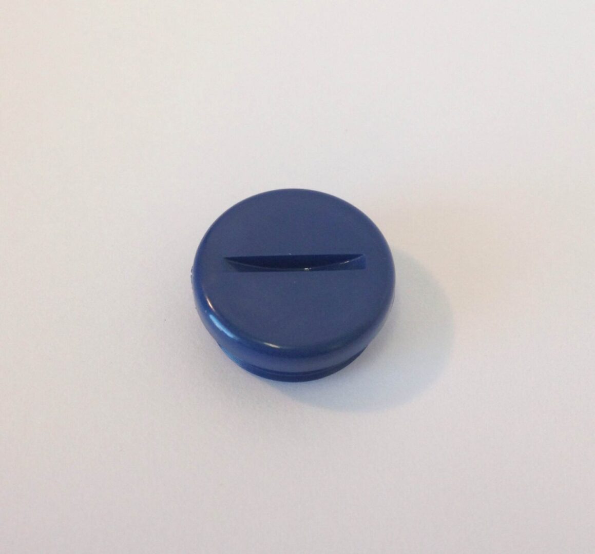 A blue button sitting on top of a table.