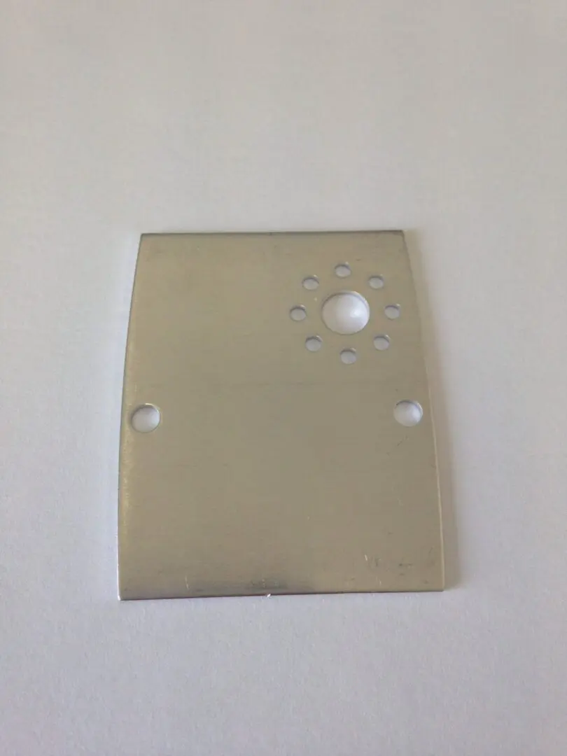A metal plate with holes for the bottom of it.