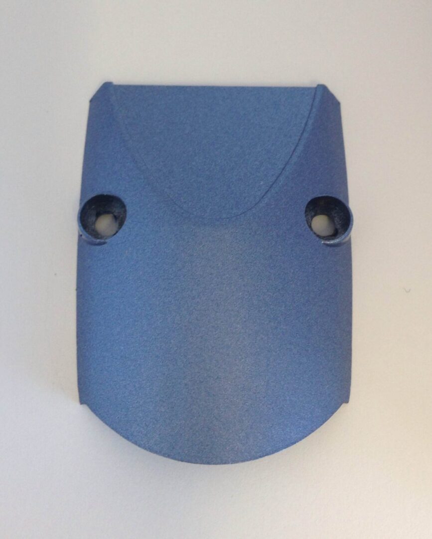 A blue plastic object with two holes in it.