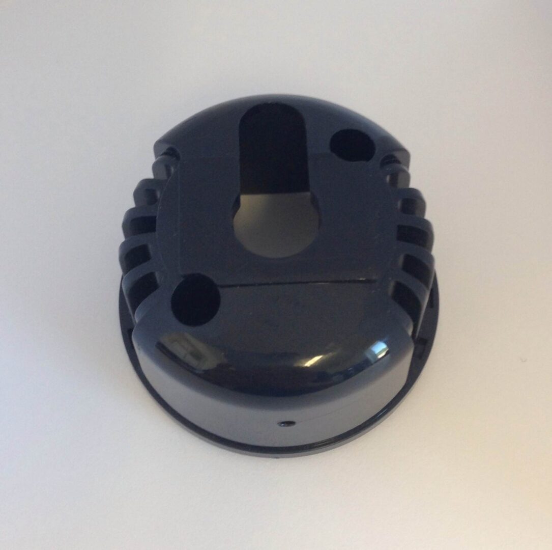 A black plastic object sitting on top of a table.