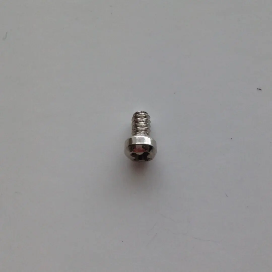 A close up of a screw on a white surface
