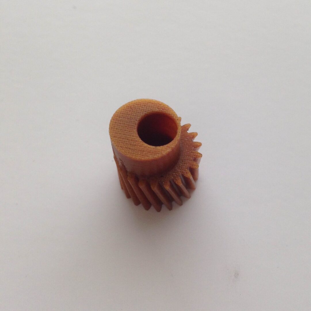 A small gear is sitting on top of the table.