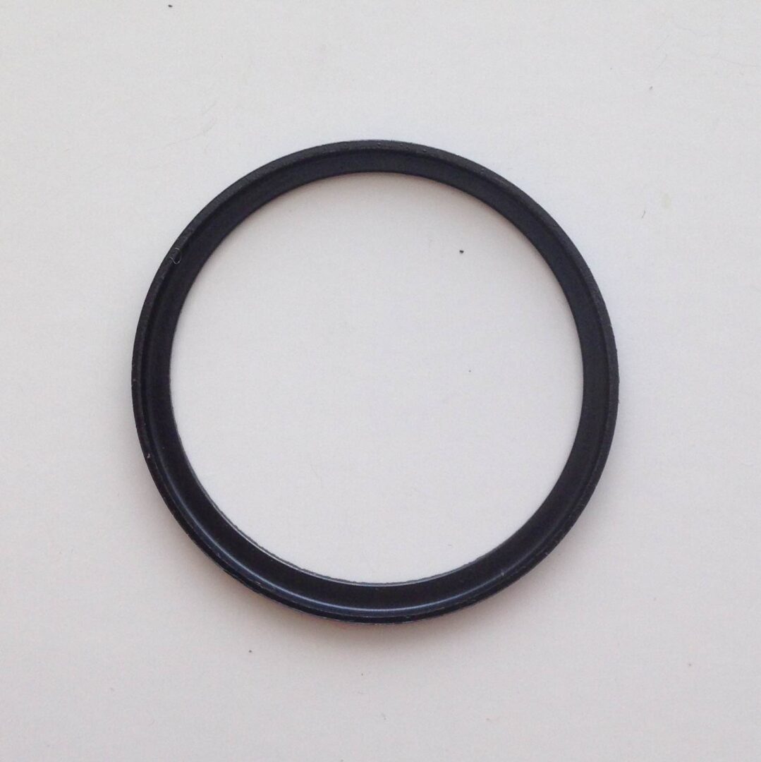 A black ring is sitting on top of the floor.