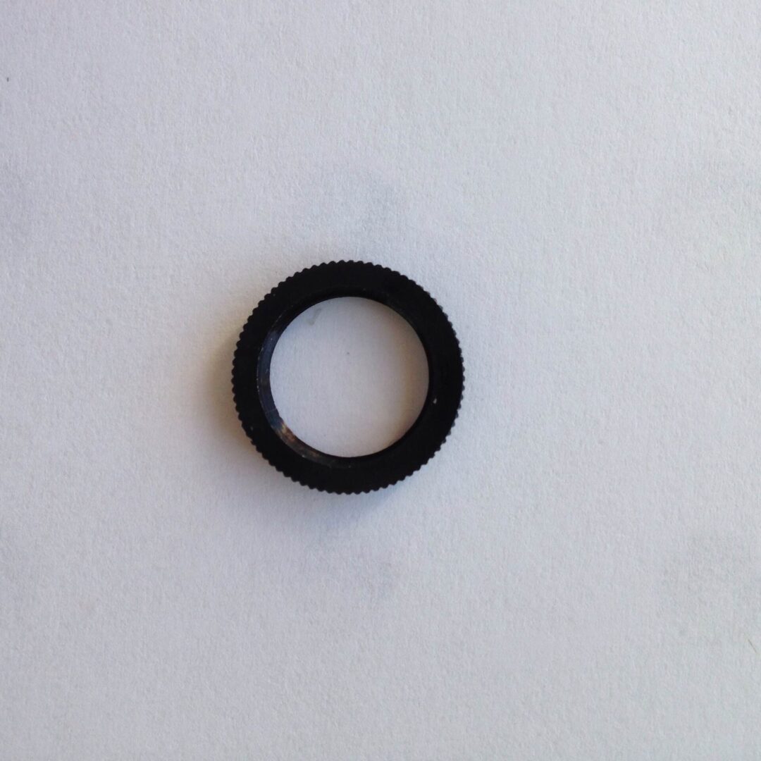 A black ring sitting on top of a white wall.
