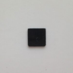 A square black button on the wall