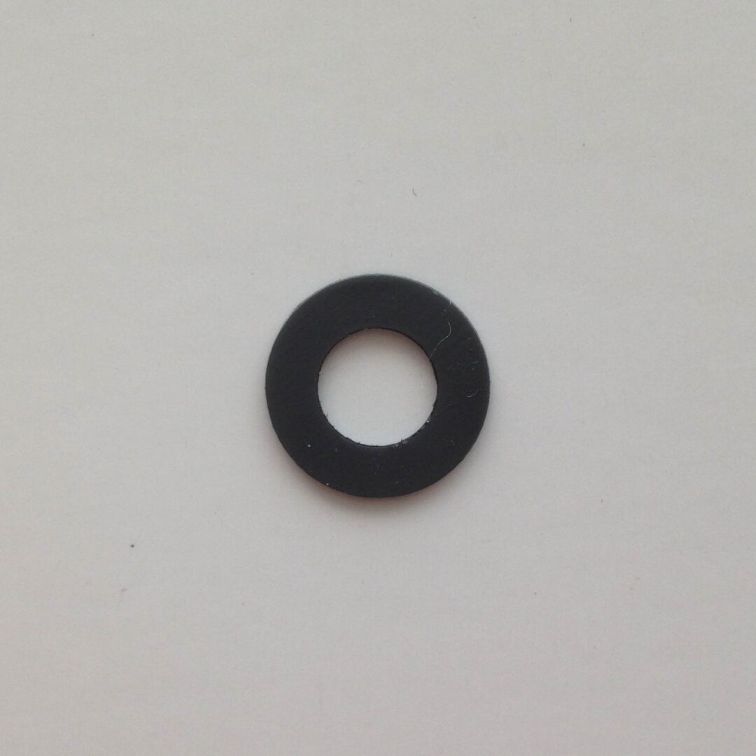 A black washer sitting on top of a white wall.