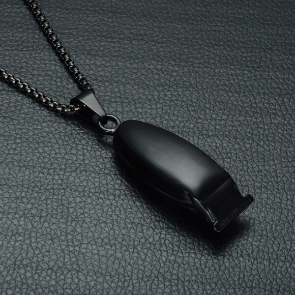 A black necklace with a metal whistle on it.