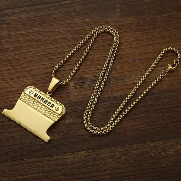 A gold necklace with a piano on it