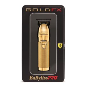 A gold colored metal hair trimmer in its packaging.