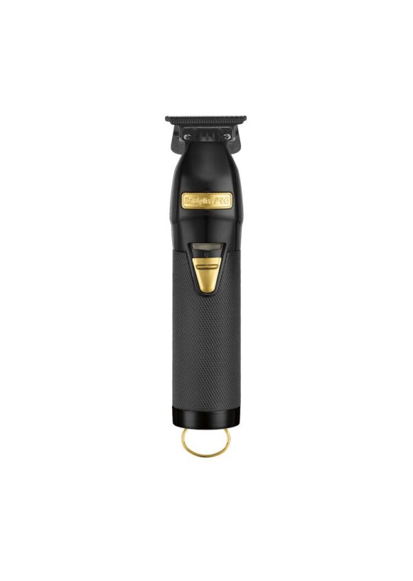A black and gold trimmer is sitting on top of the floor.