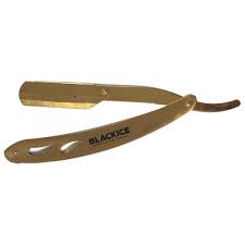 A gold colored metal scissors with black lettering.