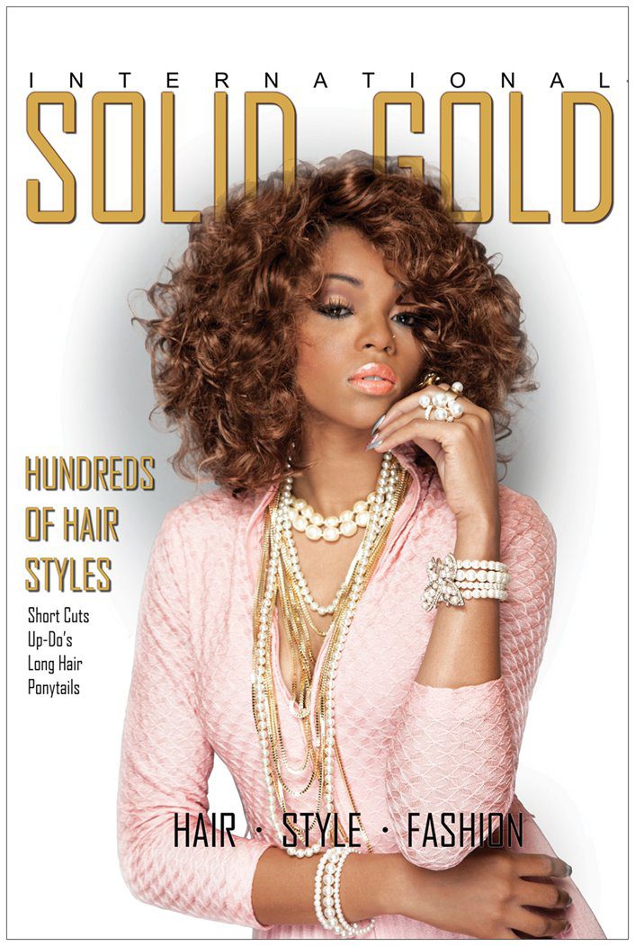 A woman with curly hair wearing jewelry and pink.