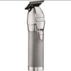A silver trimmer is sitting on the floor.