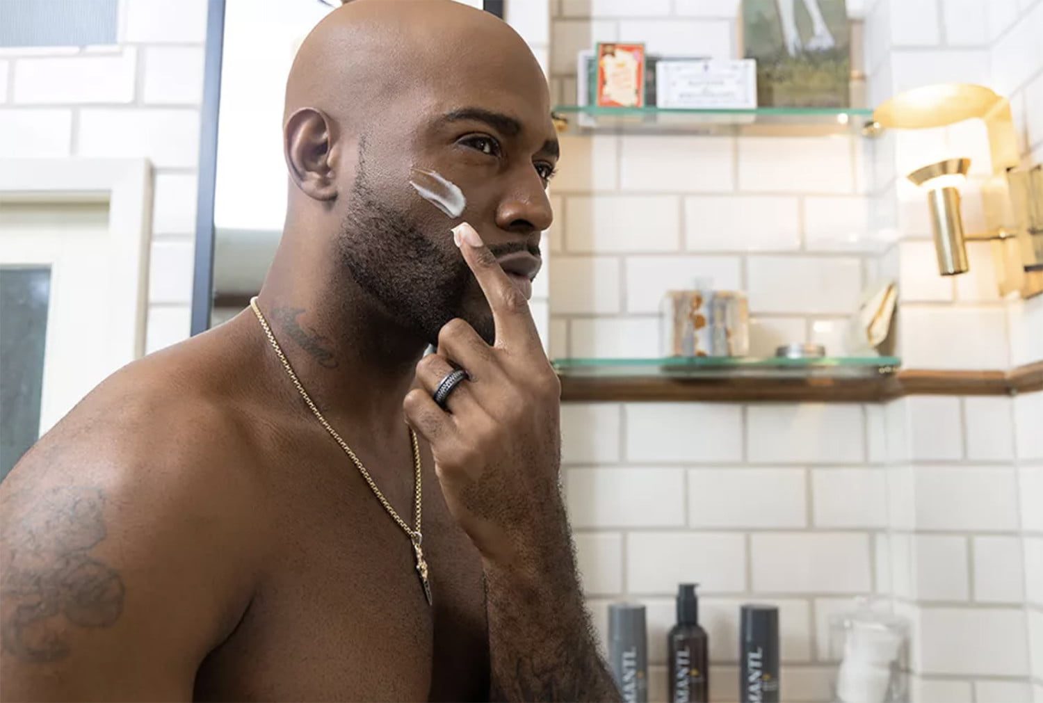 A man with bald head shaving his beard.