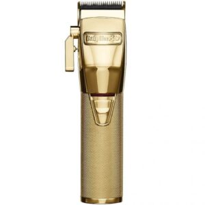 A gold trimmer is sitting on top of the floor.