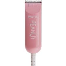 A pink hair trimmer is sitting on top of a white table.