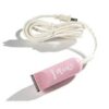 A pink hair trimmer is sitting on the floor.