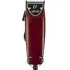 A red hair clipper sitting on top of a table.