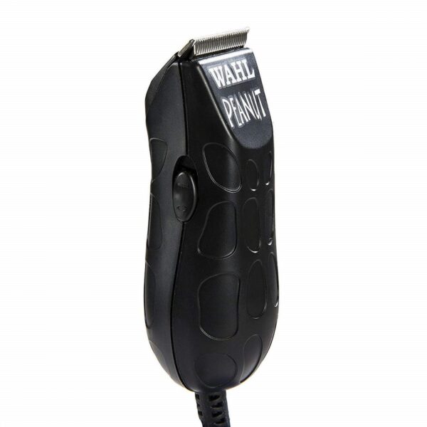 A black hair trimmer is sitting on the floor.