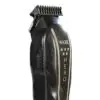 A black and silver hair trimmer sitting on top of a table.