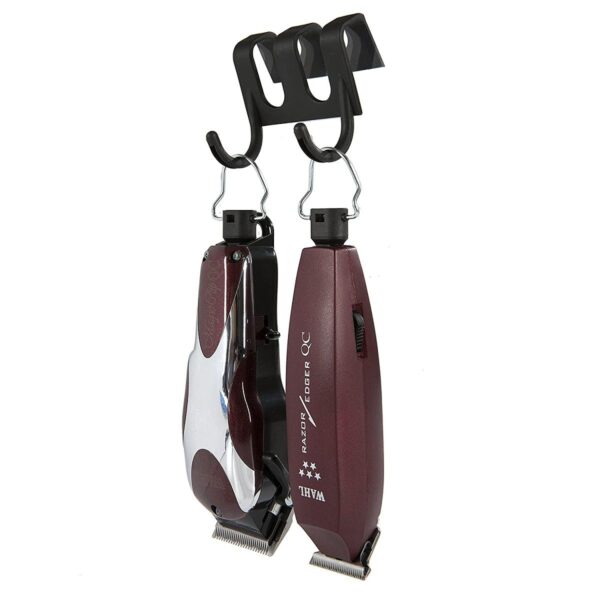 A pair of hair clippers hanging from hooks.