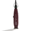 A red hair trimmer sitting on top of a white table.