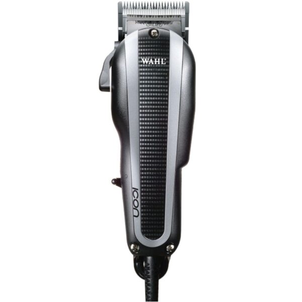 A silver and black hair clipper sitting on top of a table.