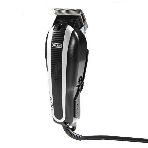 A black and silver hair clipper is on the floor.