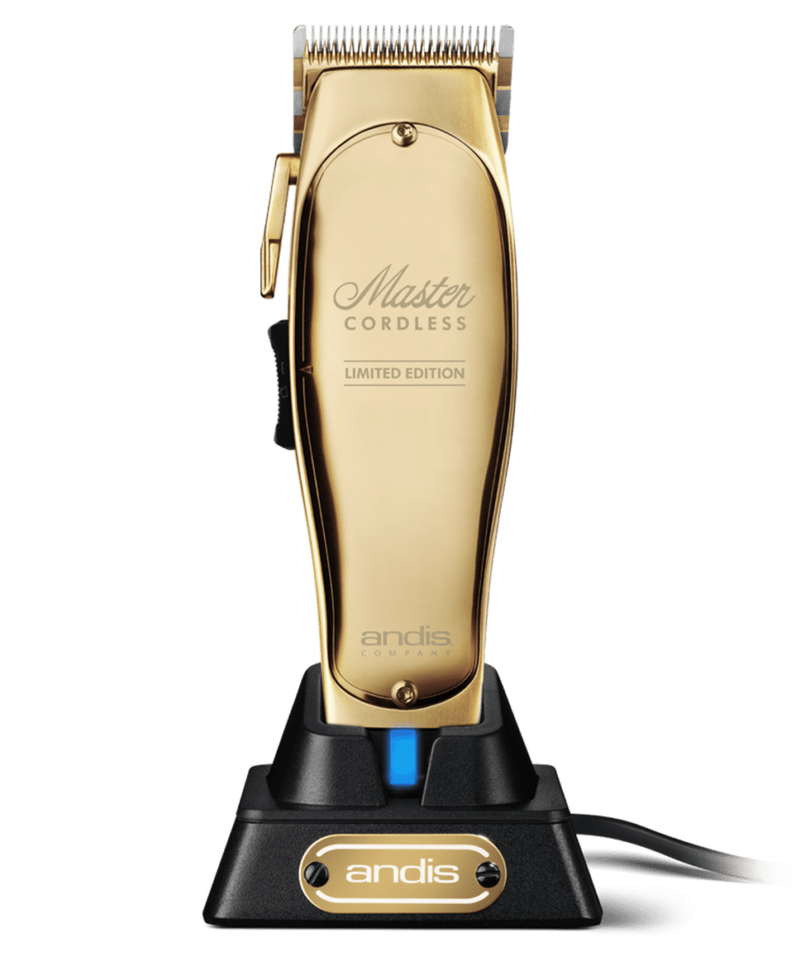 A gold plated electric shaver on top of a green background.
