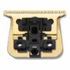 A gold comb with black plastic parts on top of it.