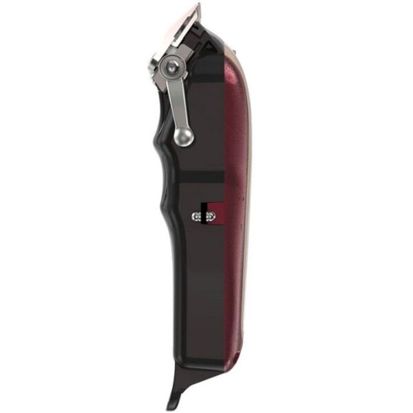 A black and red electric hair clipper on top of white background.